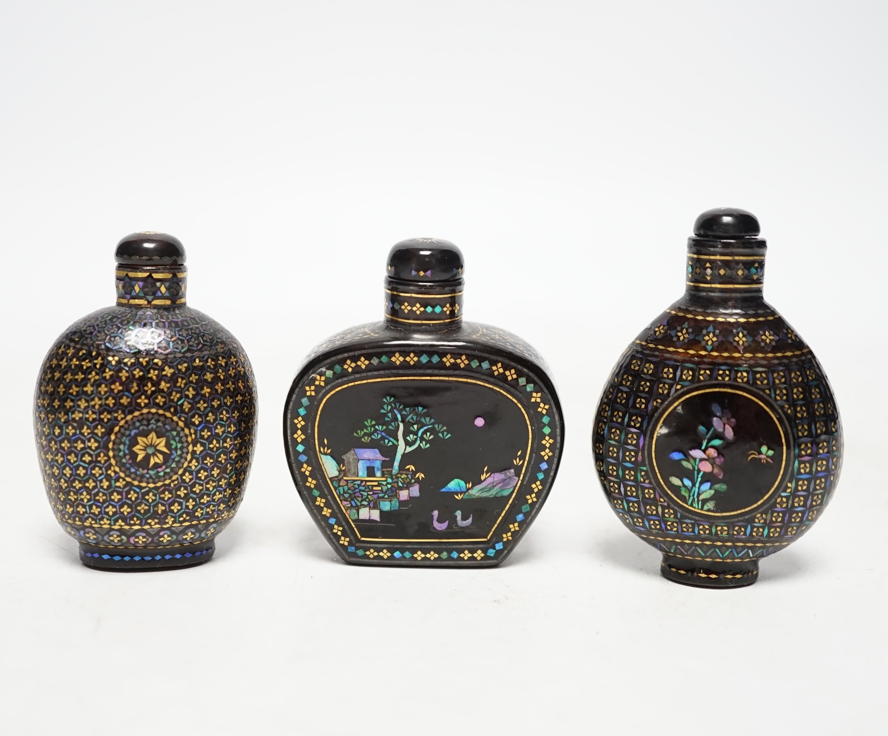 Three Chinese lac burgaute snuff bottles, 19th/20th century, largest 6cm high